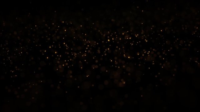 Bright glowing sparkle or glitter texture with beautiful bokeh effect. Golden dust flying around. Christmas holiday mood footage isolated on black background. Miracle and magic 4K celebration footage.