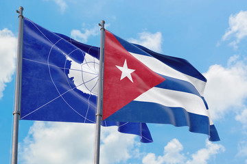 Cuba and Antarctica flags waving in the wind against white cloudy blue sky together. Diplomacy concept, international relations.