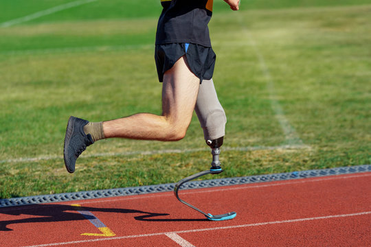 Amputee athlete participates in a race. Man with prosthetic leg
