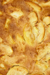 Apple pie, dessert from stewed fruits, closeup, texture, background, top view. Charlotte, homemade baking