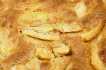 Apple pie, dessert from stewed fruits, closeup, texture, background. Charlotte, homemade baking