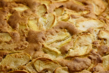 Apple pie, dessert from stewed fruits, closeup, texture, background. Charlotte, homemade baking