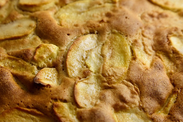 Apple pie, dessert from stewed fruits, closeup, texture, background. Charlotte, homemade baking