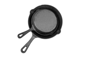 Cast iron pans isolated on white background, top view. Two black empty skillets. Kitchen equipment, cookware
