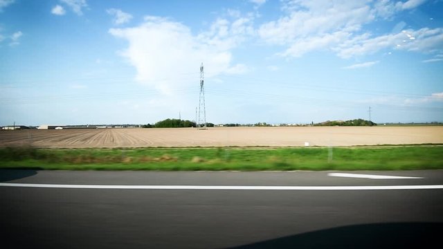Slow focusing to Renault car driving fast on French autoroute