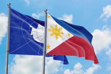 Philippines and Antarctica flags waving in the wind against white cloudy blue sky together. Diplomacy concept, international relations.