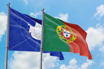 Portugal and Antarctica flags waving in the wind against white cloudy blue sky together. Diplomacy concept, international relations.