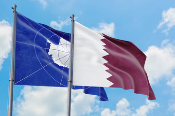 Qatar and Antarctica flags waving in the wind against white cloudy blue sky together. Diplomacy concept, international relations.