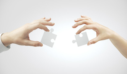 Hands putting puzzle pieces together