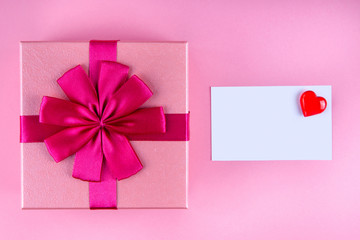 Present with Love note with red heart on pink background mock up, copyspace