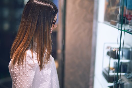 Young beautiful woman on vacation smiling happy and confident. Standing on a deck of ship with smile on face doing a cruise