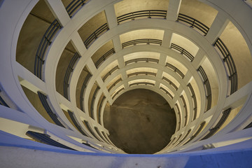 view from above into a circular parking ramp made of concrete