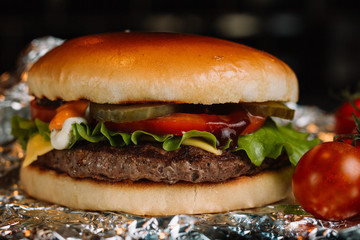 Close-up of home made tasty burgers on wooden table.