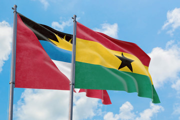 Ghana and Antigua and Barbuda flags waving in the wind against white cloudy blue sky together. Diplomacy concept, international relations.