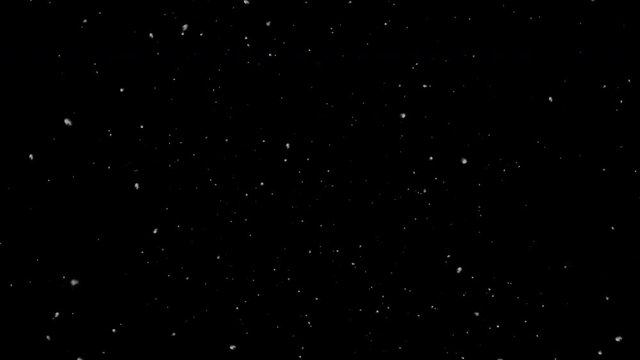 Falling snow isolated on black background in 4K Resolution. Useful for composing, motion graphics. Large and small snow snowflakes. Isolated realistic falling snowfall or snowstorm Animation