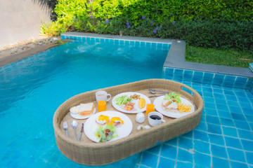 Floating breakfast around outdoor swimming pool