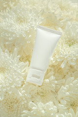 Cosmetic Tube on white flower