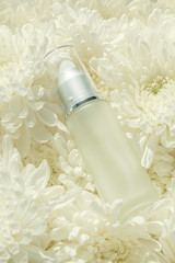 Cosmetic Bottle on white flower