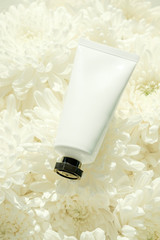 Cosmetic Tube on white flower
