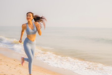 Fototapeta na wymiar Portrait sport young asian woman prepare exercise or run on the beach sea ocean