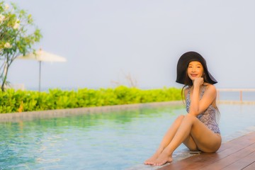 Portrait young asian woman happy smile relax around outdoor swimming pool