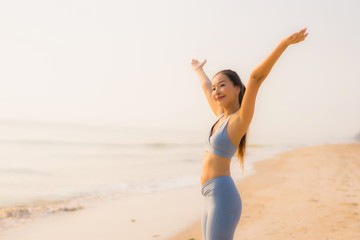 Portrait sport young asian woman prepare exercise or run on the beach sea ocean