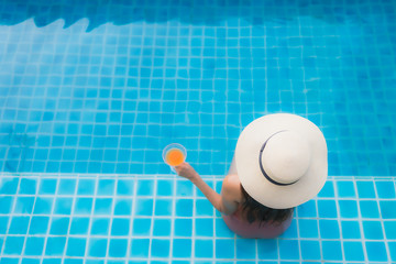 Portrait young asian woman relax happy smile around swimming pool in hotel