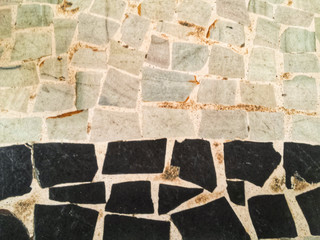 Colored decorative paving stone background - grey, orange and black stones