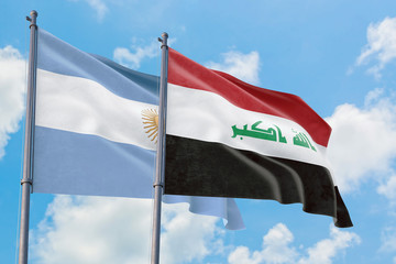 Iraq and Argentina flags waving in the wind against white cloudy blue sky together. Diplomacy concept, international relations.