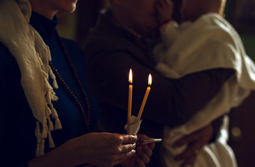 Christening in the church. Catholicism and Orthodoxy. candle on a blurred background.