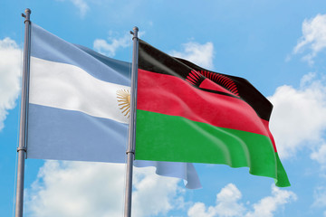 Malawi and Argentina flags waving in the wind against white cloudy blue sky together. Diplomacy concept, international relations.