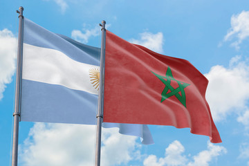 Morocco and Argentina flags waving in the wind against white cloudy blue sky together. Diplomacy concept, international relations.