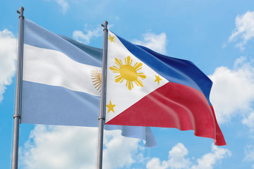 Philippines and Argentina flags waving in the wind against white cloudy blue sky together. Diplomacy concept, international relations.