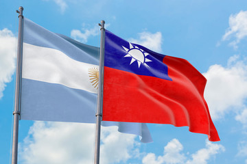 Fototapeta na wymiar Taiwan and Argentina flags waving in the wind against white cloudy blue sky together. Diplomacy concept, international relations.