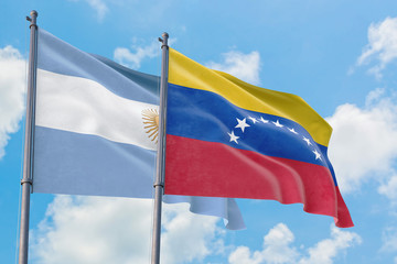 Fototapeta na wymiar Venezuela and Argentina flags waving in the wind against white cloudy blue sky together. Diplomacy concept, international relations.
