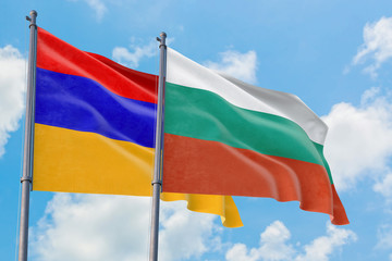 Bulgaria and Armenia flags waving in the wind against white cloudy blue sky together. Diplomacy concept, international relations.