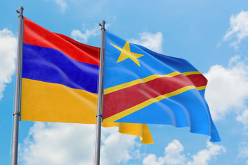 Congo and Armenia flags waving in the wind against white cloudy blue sky together. Diplomacy concept, international relations.