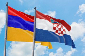 Croatia and Armenia flags waving in the wind against white cloudy blue sky together. Diplomacy concept, international relations.