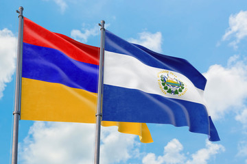 El Salvador and Armenia flags waving in the wind against white cloudy blue sky together. Diplomacy concept, international relations.