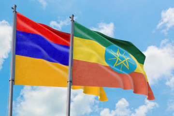 Ethiopia and Armenia flags waving in the wind against white cloudy blue sky together. Diplomacy concept, international relations.