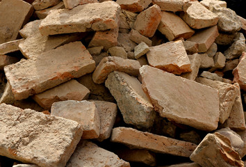 rubble with broken brick pieces from a destroyed wall after a demolition or an earthquake