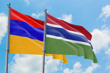 Fototapeta na wymiar Gambia and Armenia flags waving in the wind against white cloudy blue sky together. Diplomacy concept, international relations.