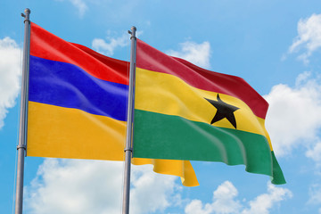 Ghana and Armenia flags waving in the wind against white cloudy blue sky together. Diplomacy concept, international relations.