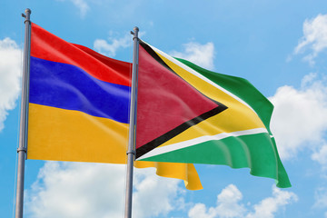 Guyana and Armenia flags waving in the wind against white cloudy blue sky together. Diplomacy concept, international relations.