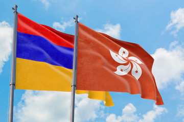 Hong Kong and Armenia flags waving in the wind against white cloudy blue sky together. Diplomacy concept, international relations.