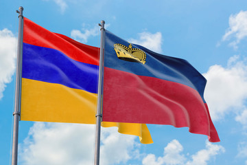 Liechtenstein and Armenia flags waving in the wind against white cloudy blue sky together. Diplomacy concept, international relations.