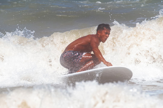 The blurry light design background of Serfer is serfing on a wave with serf board
