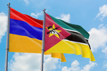 Mozambique and Armenia flags waving in the wind against white cloudy blue sky together. Diplomacy concept, international relations.