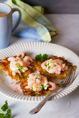 Potato cakes with topping: cream cheese and shrimps. Vegetable fritters, latkes, draniki. Vegetable pancakes