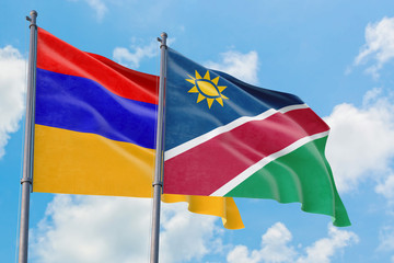 Namibia and Armenia flags waving in the wind against white cloudy blue sky together. Diplomacy concept, international relations.